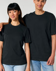 A man and woman posing for a picture in Stanley/Stella organic cotton T-shirts.