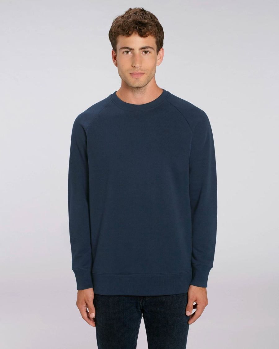 A male model wearing a Stanley/Stella French Navy organic cotton Stroller sweatshirt