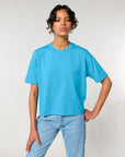 Woman in a blue STTW175 Stella Nova boxy t-shirt and jeans standing against a neutral background.