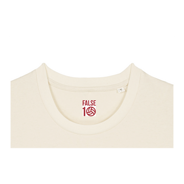 Close-up of a beige unisex STTU169 Stanley/Stella Creator 2.0 Desert Dust (C028) t-shirt with a red and white "false 15" logo printed near the neckline.