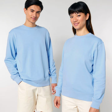 A man and woman posing for a picture in matching STSU178 Stella/Stella Changer 2.0 The Iconic Unisex Crew Neck Sweatshirts made of BRUSHED FLEECE by Stanley/Stella.