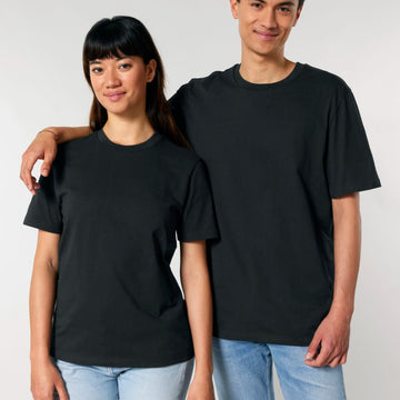 Two people smiling and wearing plain black Stanley/Stella Creator 2.0 The Iconic Unisex T-Shirts.