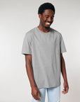 Man smiling and wearing a plain gray Stanley/Stella Creator 2.0 The Iconic Unisex T-Shirt.