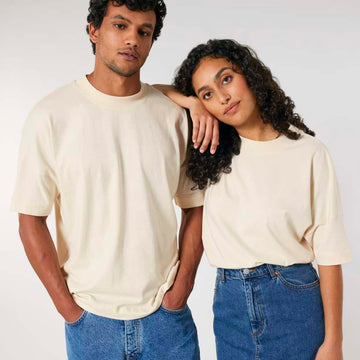 A man and woman in matching Stanley/Stella STTU815 Blaster Oversized High Neck Organic Cotton Unisex T-shirts posing for a picture.