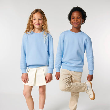 Two Stanley/Stella kids in blue STSK181 Stella Mini Changer 2.0 The Iconic Kids' Crew Neck Sweatshirts posing for a photo.