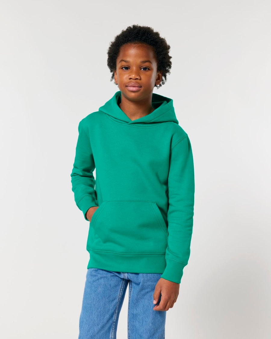 A young boy wearing a STSK180 Stella/Stella Mini Cruiser 2.0 The Iconic Kids Hoodie sweatshirt and jeans.
