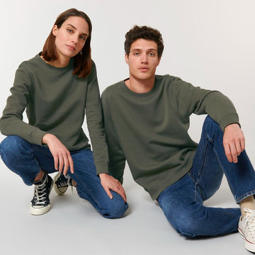 Two models in test demo STSU868 Stanley/Stella Roller Organic Cotton Essential Sweatshirts and blue jeans sitting side by side against a white background, showcasing My Needs Are Simple brand.