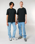 Two men wearing black Stanley/Stella Sparker 2.0 The Unisex Heavy T-shirts and jeans.
