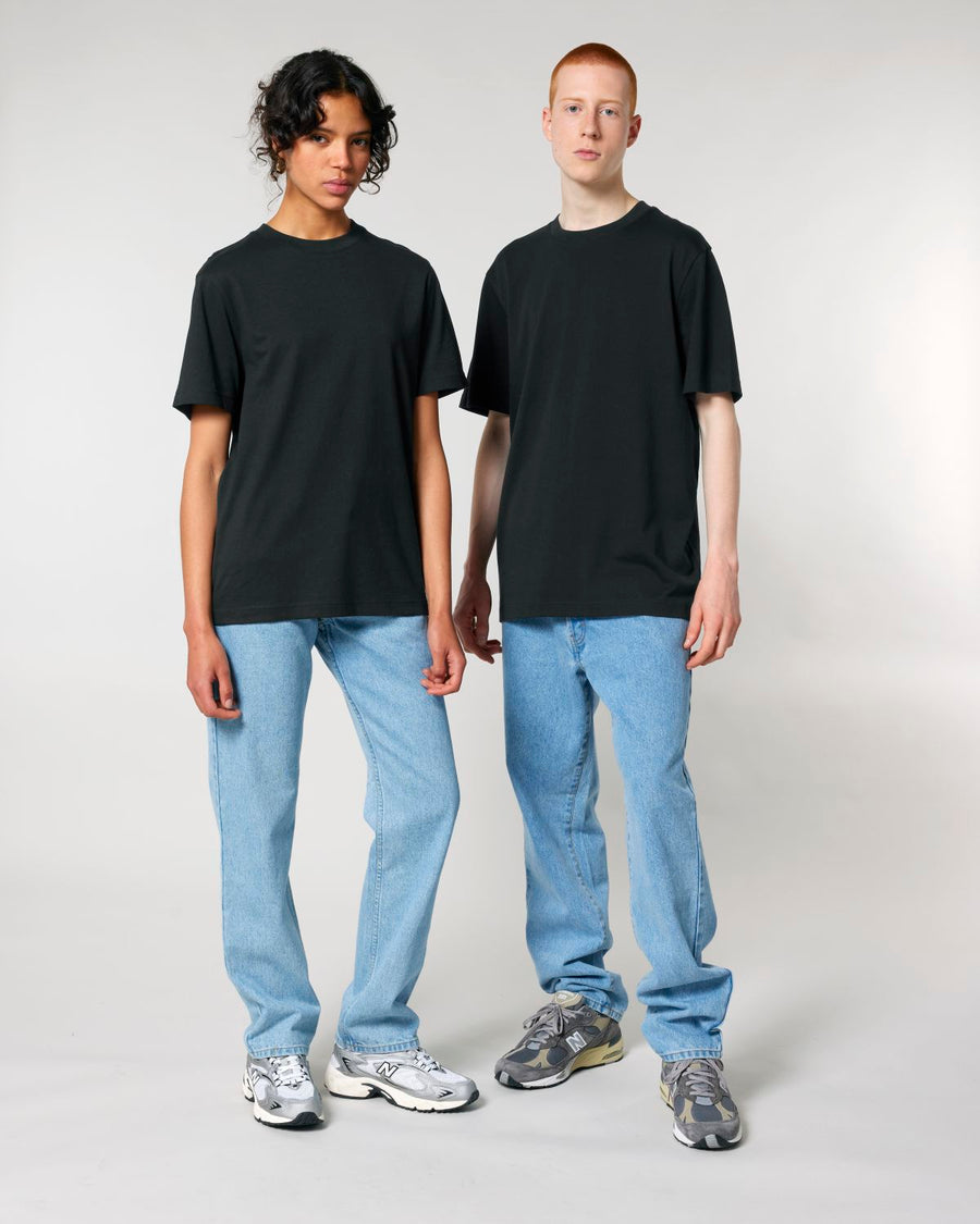 Two men wearing black Stanley/Stella Sparker 2.0 The Unisex Heavy T-shirts and jeans.