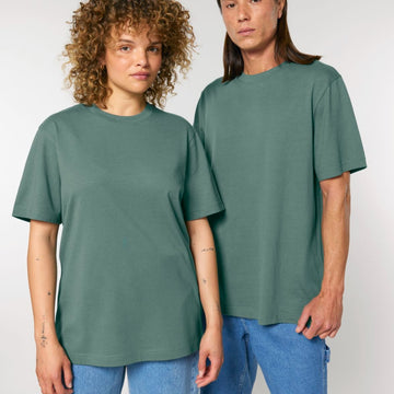 A man and woman wearing matching Stanley/Stella STTU171 Sparker 2.0 The Unisex Heavy T-Shirts, posing for a picture.