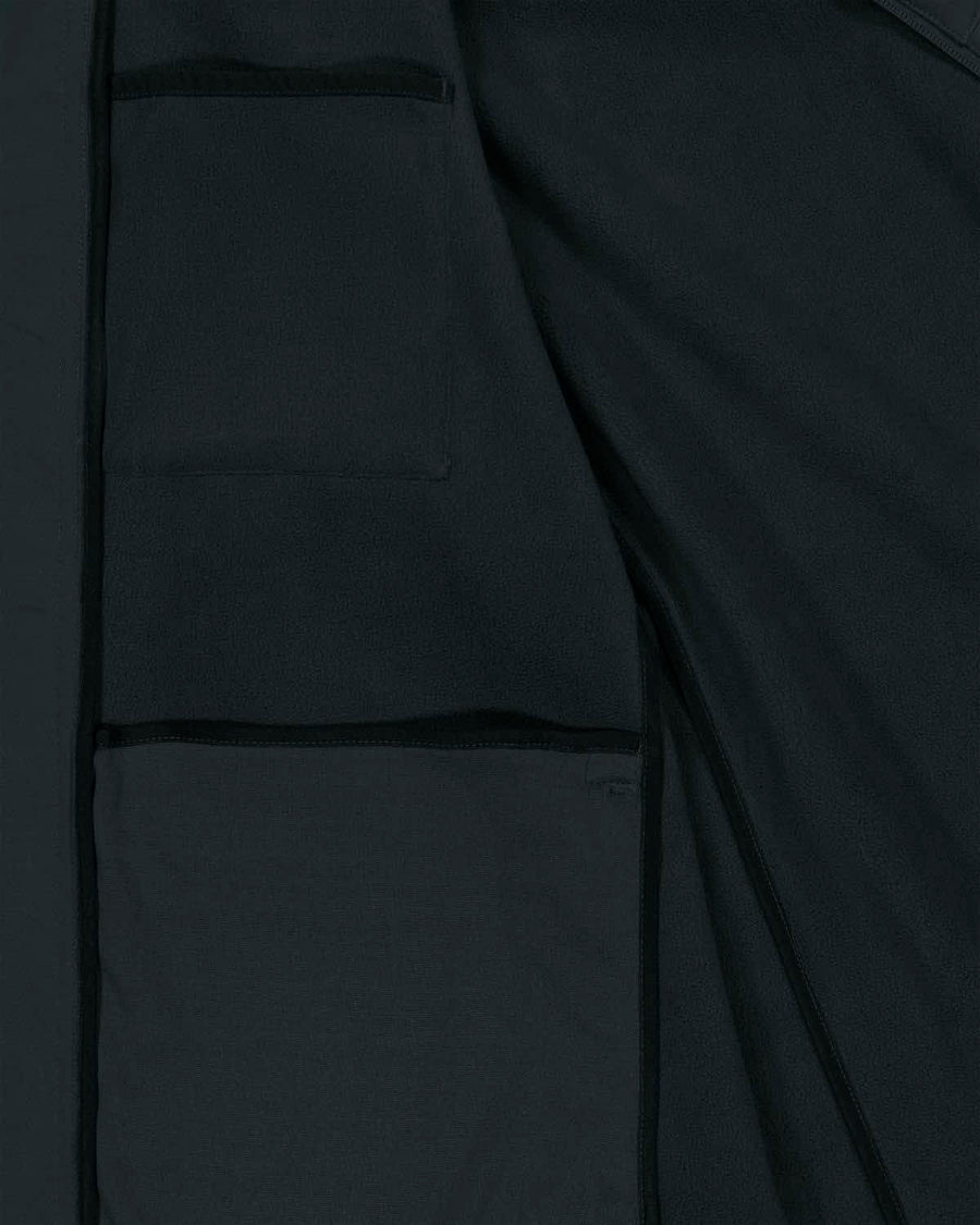 Close-up of a dark gray MyNeedsAreSimple STJM167 Stanley/Stella Navigator Men's Non-Hooded Softshell jacket with visible stitching and pockets, highlighting the texture and details of the recycled polyester material.