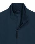 Close-up of a navy blue MyNeedsAreSimple STJM167 Stanley/Stella Navigator Men's Non-Hooded Softshell jacket with a zippered front and raised collar.