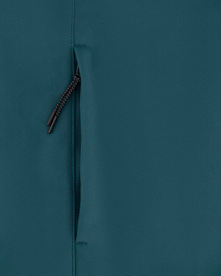 A closed, dark zipper on a textured teal recycled polyester fabric background of the STJM167 Stanley/Stella Navigator Men's Non-Hooded Softshell by MyNeedsAreSimple.