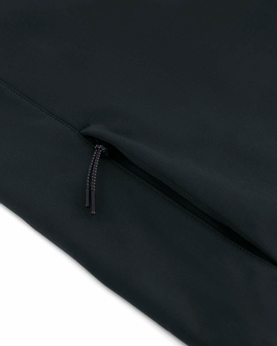 Close-up of a black zipper partially open on a smooth, windproof MyNeedsAreSimple STJW166 Stanley/Stella Navigator Women’s Non-Hooded Softshell fabric surface.