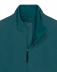 Close-up of a dark teal MyNeedsAreSimple Navigator Women’s Non-Hooded Softshell jacket with a raised collar and a partially unzipped front, showing fleece lining.
