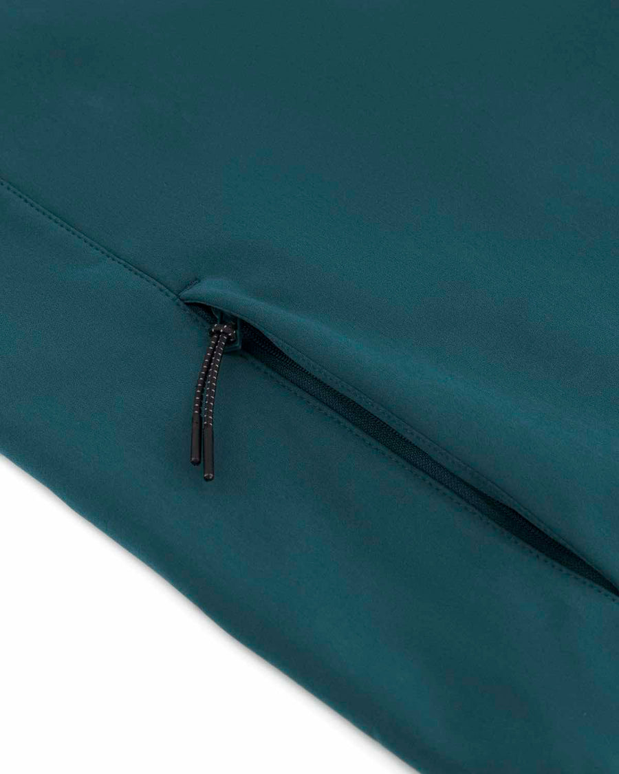 Close-up of a dark teal, water-repellent fabric with a black zipper, highlighting the texture and zipper details of the STJW166 Stanley/Stella Navigator Women’s Non-Hooded Softshell by MyNeedsAreSimple.