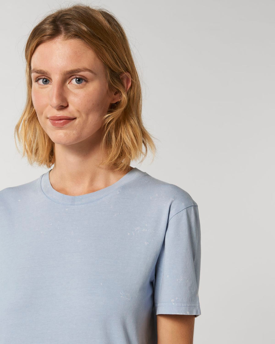 A woman wearing a Stanley/Stella organic cotton blue T-shirt.
