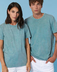 A man and woman are posing for a photo in a Stanley/Stella Creator Vintage Unisex T-Shirt made from organic cotton.