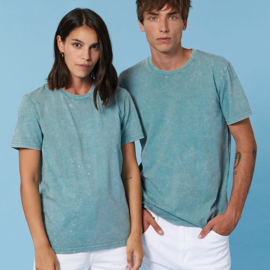 A man and woman are posing for a photo in a Stanley/Stella Creator Vintage Unisex T-Shirt made from organic cotton.