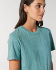 A woman wearing a blue STTU831 Stanley/Stella Creator Vintage Unisex T-Shirt.
