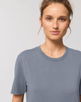 A woman wearing a Stanley/Stella organic cotton grey STTU831 Creator Vintage Unisex T-Shirt.