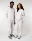 Two people wearing matching Stanley/Stella gray fleece sweatshirts and sweatpants with coordinating sneakers posing together.