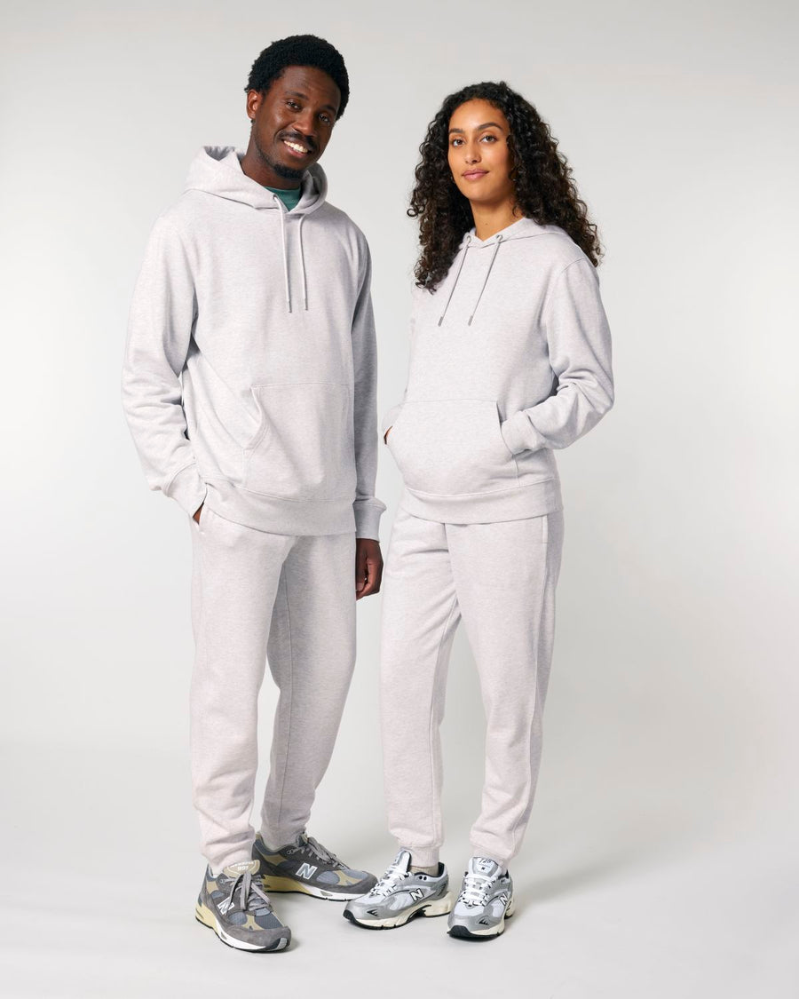 Two people wearing matching Stanley/Stella gray fleece sweatshirts and sweatpants with coordinating sneakers posing together.