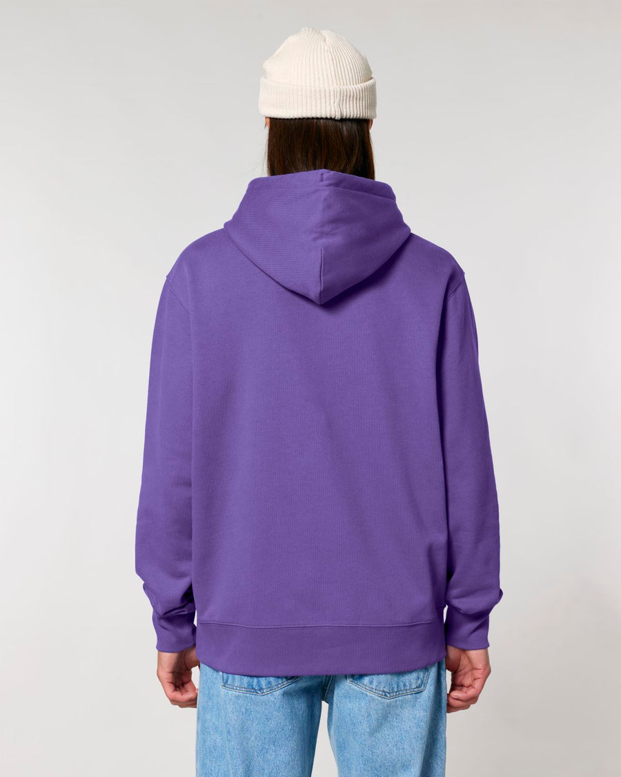 Person standing with their back to the camera wearing a purple STSU177 Stella/Stella Cruiser 2.0 The Iconic Unisex Hoodie Sweatshirt and a white beanie, paired with blue jeans.