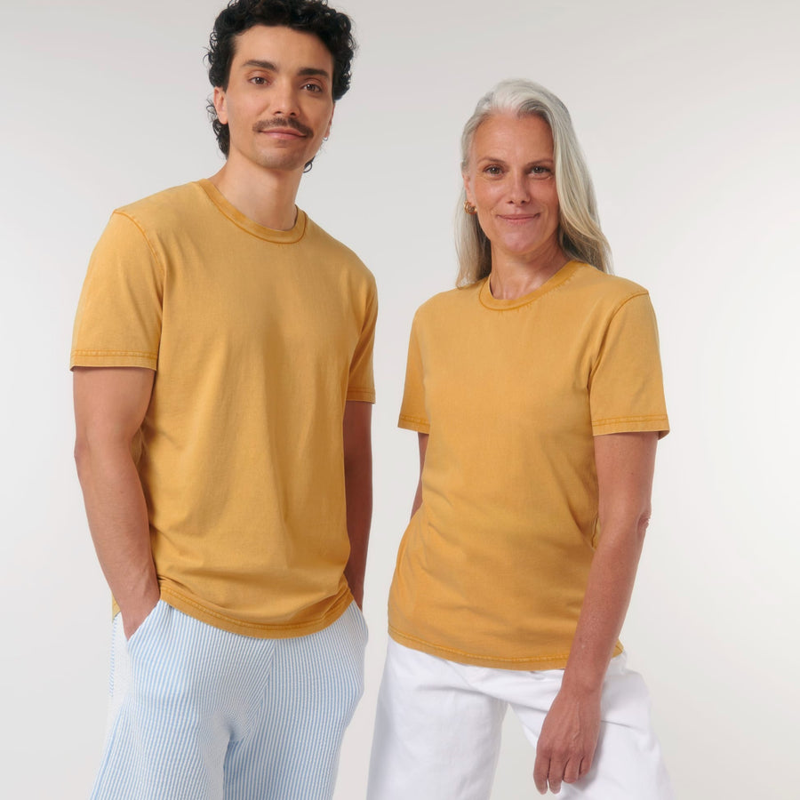 A man and a woman wearing yellow Stanley/Stella Creator Vintage Unisex T-shirts made from organic cotton.