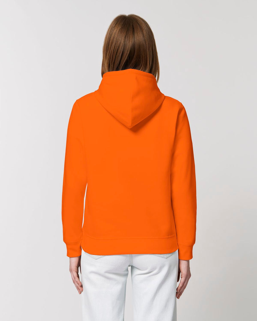 The back view of a woman wearing an STSU812 Stanley/Stella Drummer Hoodie Bright Orange (C013) made from organic ring-spun combed cotton.