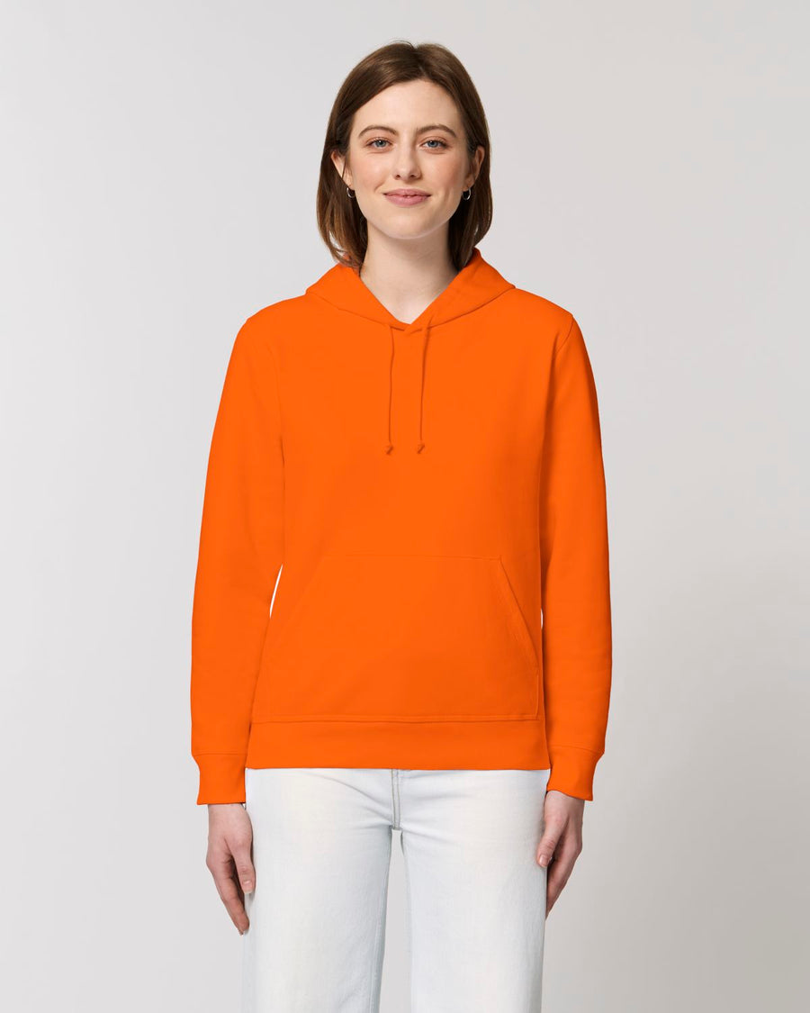 A woman wearing the STSU812 Stanley/Stella Drummer Hoodie Bright Orange (C013) hooded sweatshirt made of organic ring-spun combed cotton.