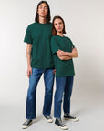 A man and woman wearing Stanley/Stella Freestyler Heavy Organic Cotton Unisex T-shirt and jeans.
