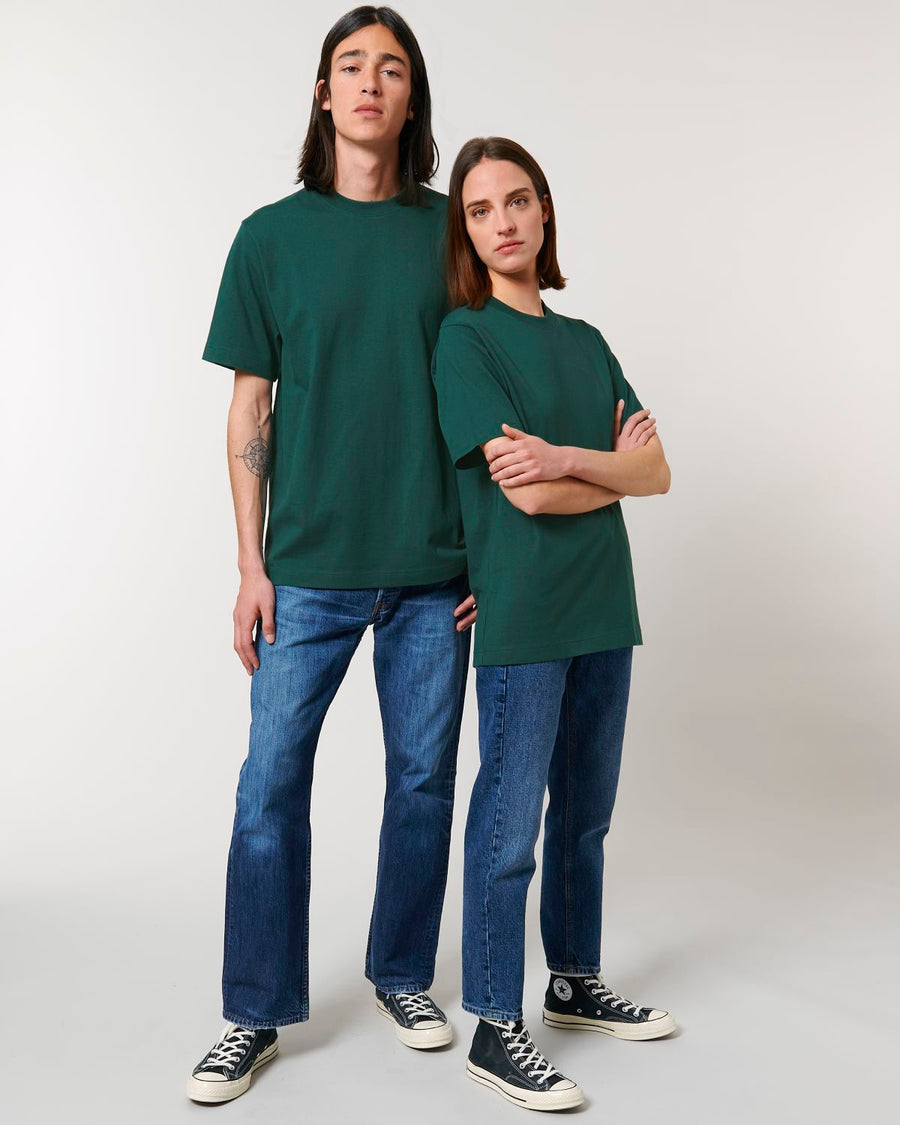 A man and woman wearing Stanley/Stella Freestyler Heavy Organic Cotton Unisex T-shirt and jeans.