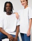 A man and woman posing for a photo in a white Stanley/Stella Freestyler Heavy Organic Cotton Unisex T-shirt.