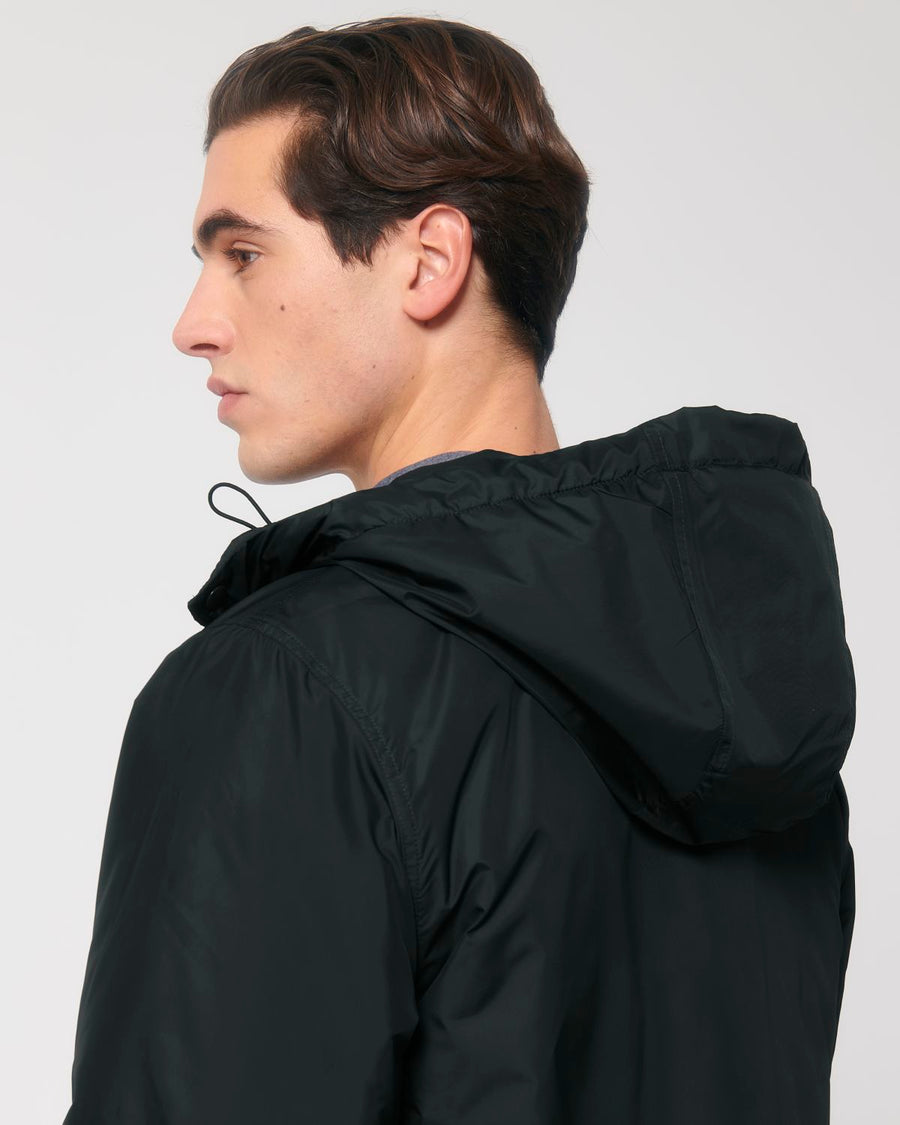 The back view of a unisex man wearing a black hooded Stanley/Stella Padded Parker Jacket with decoration.