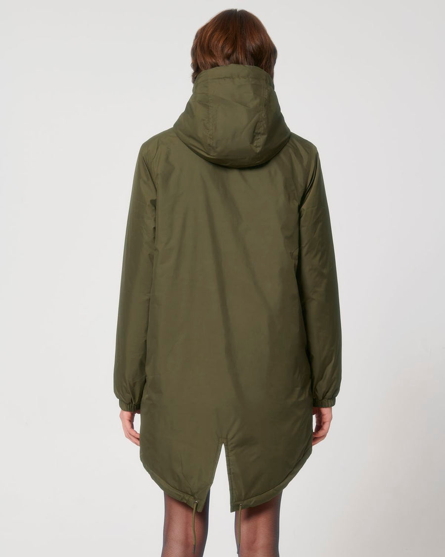 The back view of a woman wearing a STJU841 Stanley/Stella Padded Parker Jacket in green.