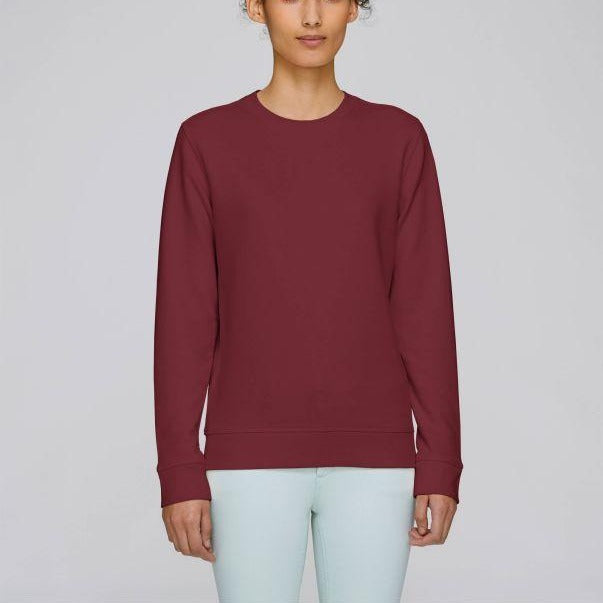 A Stanley/Stella Rise eco-friendly Sweatshirt in burgundy worn by a female model