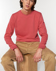 A Stanley/Stella Organic Cotton Sweatshirt in red worn by a male model