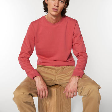 A Stanley/Stella Organic Cotton Sweatshirt in red worn by a male model