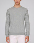 A Stanley/Stella Organic Cotton Sweatshirt in Heather Grey worn by a male model