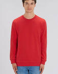 A Stanley/Stella Rise sustainable Sweatshirt in red worn by a male model