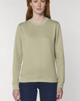 A Stanley/Stella Rise eco-friendly Sage Sweatshirt worn by a female model
