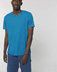 A male model wearing an organic azur Stanley/Stella rocker T-Shirt