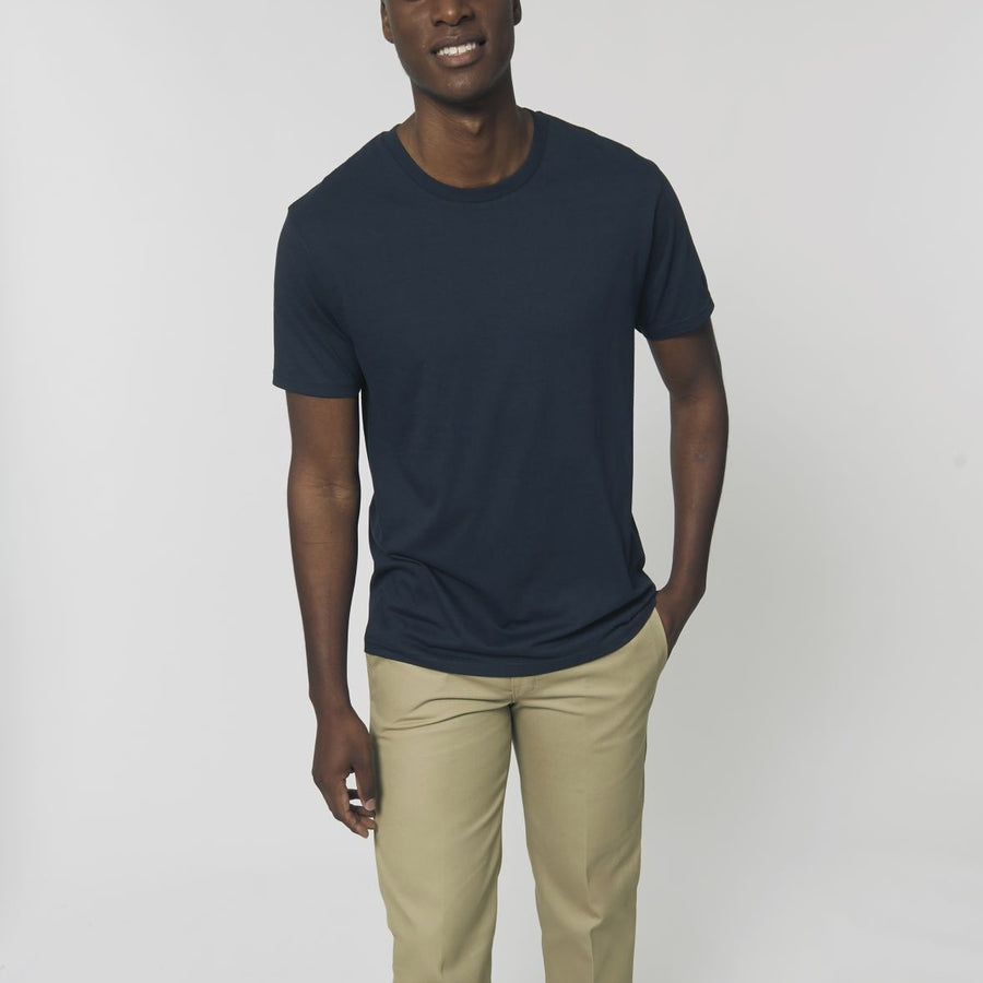 A male model wearing an organic French Navy Stanley/Stella rocker T-Shirt