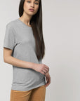 A female model wearing an organic heather grey Stanley/Stella rocker T-Shirt