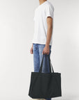 A black organic cotton shopping bag by Stanley/Stella