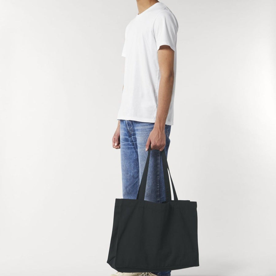 A black organic cotton shopping bag by Stanley/Stella