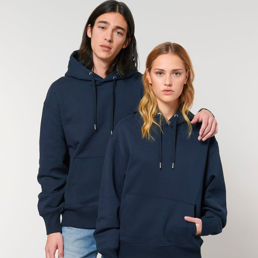 A man and a woman wearing a Stanley/Stella Slammer Heavy Relaxed Organic Cotton Unisex Hoodie.