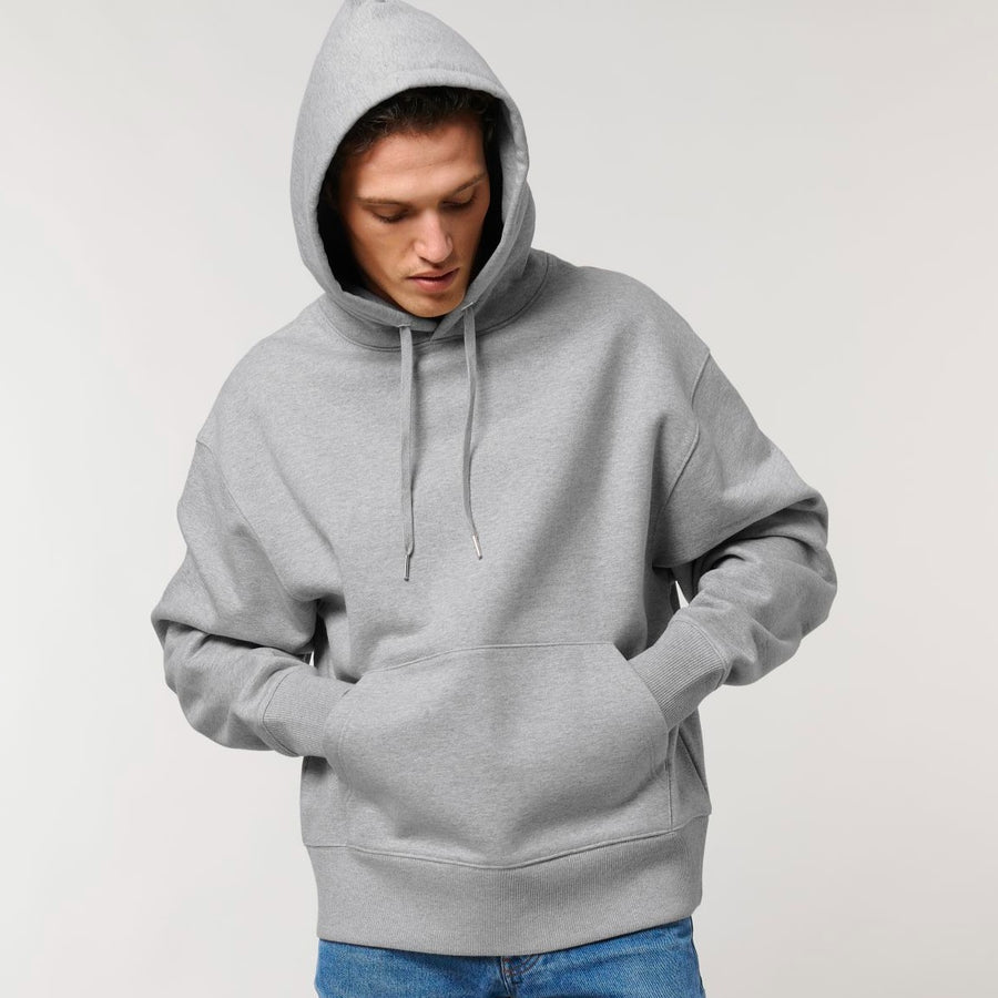 An individual donning a Stanley/Stella Slammer Heavy Relaxed Organic Cotton Unisex Hoodie.