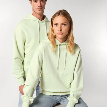 A man and a woman wearing a Stanley/Stella Slammer Relaxed Organic Cotton Unisex Hoodie.
